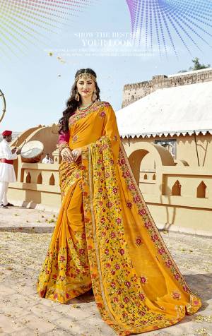 Celebrate This Festive Season Wearing This Designer Saree In Yellow Color Paired With Contrasting Dark Pink Colored Blouse. This Saree IS Fabricated On Georgette Paired With Art Silk Fabricated Blouse. It Has Pretty Contrasting Embroidery all Over. 

