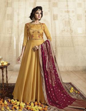 Celebrate This Festive Season With Ease And Comfort Wearing This Designer Floor Length Readymade Gown In Musturd Yellow Color Paired With Contrasting Maroon Colored dupatta. Its Top Is Fabricated On Satin Linen Paired With Jacquard Silk Fabricated Dupatta. Buy This Readymade Suit Now.