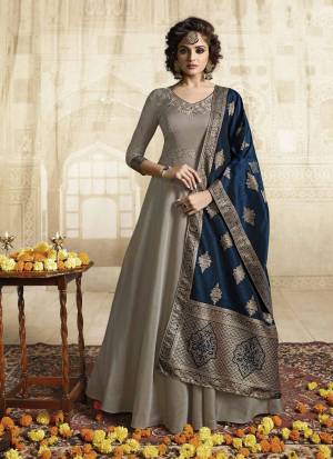 Flaunt Your Rich And Elegant Taste Wearing This Designer Floor Length Suit In Grey Colored Top Paired With Contrasting Navy Blue Colored Dupatta. This Readymade Gown Is Fabricated On Satin Silk Paired With Jacquard Silk Fabricated Dupatta. It Is Avialable In All Regular Sizes. Buy Now.