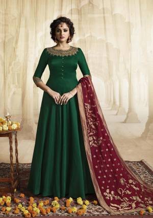 Catch All The Limelight Wearing This Designer Readymade Floor Length Suit In Dark Green Color Paired With Contrasting Maroon Colored Dupatta. Its Top Is Fabricated On Satin Linen Paired With Jacquard Silk Fabricated Dupatta. It Has Attractive Embroidery Over The Neckline And Sleeves. Buy Now.