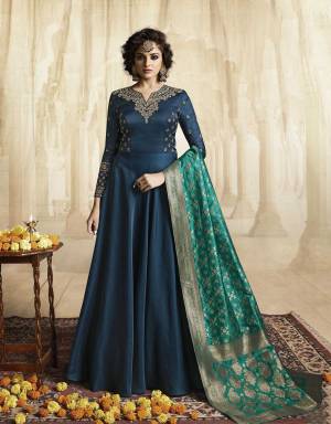 Go with The Shades Of Blue With This Designer Floor Length Gown In Blue Color Paired With Turquoise Blue Colored Dupatta. This Readymade Gown Is Fabricated On Satin Linen Paired With Jacquard Silk Fabricated Dupatta. It Is Light In Weight and Easy To Carry All Day Long.
