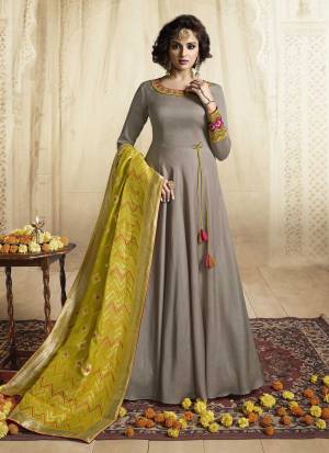Flaunt Your Rich And Elegant Taste Wearing This Designer Floor Length Suit In Grey Colored Top Paired With Contrasting Pear Green Colored Dupatta. This Readymade Gown Is Fabricated On Satin Silk Paired With Jacquard Silk Fabricated Dupatta. It Is Avialable In All Regular Sizes. Buy Now.