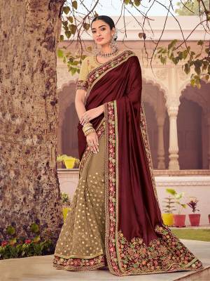 Impress everyone with your amazing Trendy look by draping this maroon and brown color two tone satin saree. this party wear saree won't fail to impress everyone around you. this gorgeous saree featuring a beautiful mix of designs. Its attractive color and designer heavy embroidered design, stone design work, beautiful floral design all over in saree work over the attire & contrast hemline adds to the look. Comes along with a contrast unstitched blouse.