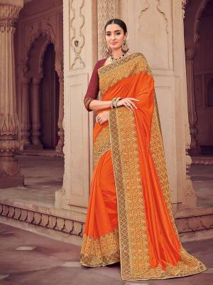Classy, sensuous and versatile are the perfect words to describe this orange color silk fabric saree. Ideal for party, festive & social gatherings. this gorgeous saree featuring a beautiful mix of designs. Its attractive color and designer heavy embroidered design, stone design work, beautiful floral design all over in saree work over the attire & contrast hemline adds to the look. Comes along with a contrast unstitched blouse.