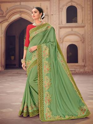 Change your wardrobe and get classier outfits like this gorgeous Light green color two tone satin silk saree. Ideal for party, festive & social gatherings. this gorgeous saree featuring a beautiful mix of designs. Its attractive color and designer heavy embroidered design, moti design work, patch design, beautiful floral design all over in saree work over the attire & contrast hemline adds to the look. Comes along with a contrast unstitched blouse.