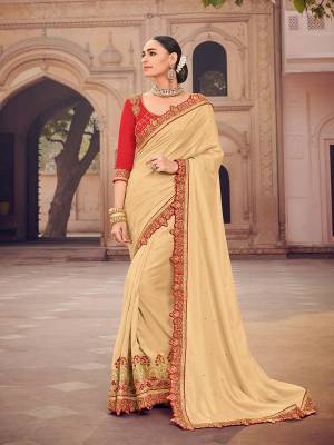 Show your elegance by wearing this gorgeous beige color satin silk saree. Ideal for party, festive & social gatherings. this gorgeous saree featuring a beautiful mix of designs. Its attractive color and designer heavy embroidered design, moti design work, patch design, beautiful floral design all over in saree work over the attire & contrast hemline adds to the look. Comes along with a contrast unstitched blouse.
