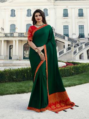 Here Is A Proper Traditional Looking Designer Saree In Dark Green Paired With Contrasting Red Colored Blouse. This Saree Is Fabricated On Georgette And Jacquard Silk Paired With Art Silk Fabricated Blouse. 