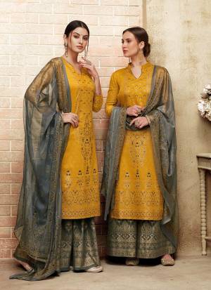Rich And Unique Color Combination Is Here With This Designer Straight Suit In Yellow Colored Top Paired With Contrasting Grey Colored Bottom And Dupatta. Its Top Is Silk Based Paired With Cotton Bottom And Chiffon Dupatta. Buy Now.