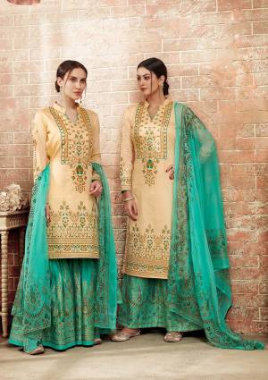 Rich And Unique Color Combination Is Here With This Designer Straight Suit In Beige Colored Top Paired With Contrasting Sea Green Colored Bottom And Dupatta. Its Top Is Silk Based Paired With Cotton Bottom And Chiffon Dupatta. Buy Now.