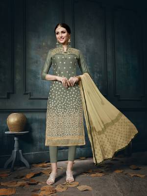 Add This Lovely Shade To Your Wardrobe With This Dress Material In olive Green Colored Top And Bottom Paired With Beige Colored Dupatta. It Is Cotton Based Paired With Chiffon Fabricated dupatta. Buy Now.