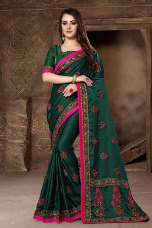 Flaunt Your Rich And Elegant Taste Wearing This Designer Saree In Dark Green Color Paired With Dark Green Colored Blouse. This Saree And Blouse Are Fabricated On Satin Silk Beautified With Heavy Resham And Jari Work. It Is Suitable For All Occasion Wear. 