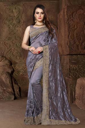 Get Ready For The Upcoming Festive And Wedding Season With This Heavy Designer Saree In Dark Grey Color Paired With Dark Grey Colored Blouse. This Saree Is Fabricated In Art Silk Paired With Satin Silk Fabricated Blouse. Its Heavy Embroidery And Rich Fabric Will Earn You Lots Of Compliments From Onlookers. 