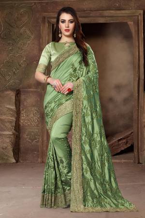 Get Ready For The Upcoming Festive And Wedding Season With This Heavy Designer Saree In Green Color Paired With Green Colored Blouse. This Saree Is Fabricated In Art Silk Paired With Satin Silk Fabricated Blouse. Its Heavy Embroidery And Rich Fabric Will Earn You Lots Of Compliments From Onlookers. 