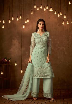 This Season Is About Subtle Shades And Pastel Play, So Grab This Designer Semi-Stitched Suit In Pastel Green Color Paired With Pastel Green Colored Bottom And Dupatta. Its Top Is Fabricated On Heavy Embroidered Net Paired With Satin raw Silk Bottom And Net Fabricated Dupatta. Buy Now.