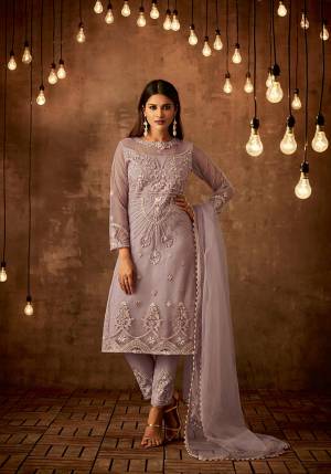 New And Pretty Shade Is Here With This Designer Straight Suit In Lilac Color Paired With Lilac Colored Bottom And Dupatta, Which Is Hue Of Purple. This Semi-Stitched Suit Is Fabricated On Net Paired With Satin Raw Silk Bottom And Net Fabricated Dupatta. Buy This Now. 