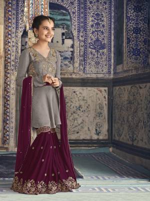 Grab This Beautiful Sharara Suit for You And Your Daughter In Grey Colored Top Paired With Dark Pink Colored Bottom And Dupatta. Its Top And Bottom Are Fabricated On Georgette Paired With Chiffon Fabricated Dupatta. 