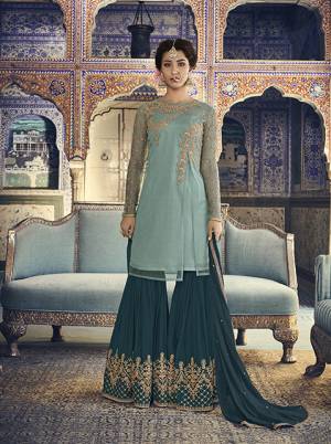 Go With The Shades Of Blue Which Suits Every Age Group, Be It A Mother Or Daughter. Its Top Is In Aqua Blue Color Paired With Teal Blue Colored Bottom And Dupatta. Its Top Is Fabricated On Net Paired With Georgette Bottom And Chiffon Dupatta. It Has Pretty Attractive Embroidery Over The Top And Bottom. 