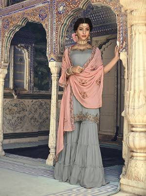 For A Rich And Elegant Look For You And Your Daughter Here Is A Perfect Sharara Suit In Grey Colored Top And Bottom Paired With Contrasting Peach Colored Dupatta. Its Top And Bottom Are Fabricated On Georgette Paired With Chiffon Dupatta. Buy Now.