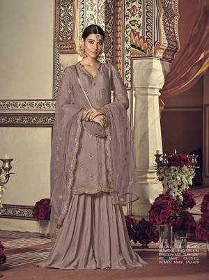 Here Is A Very Beautiful Shade In Purple With This Designer Sharara Suit In Mauve Color For You And Your Daughter. This Pretty Suit Is Georgette Based Paired With Net Fabricated Dupatta. It Is Beautified With Attractive Embroidery Over The Top And Dupatta. Buy Now.