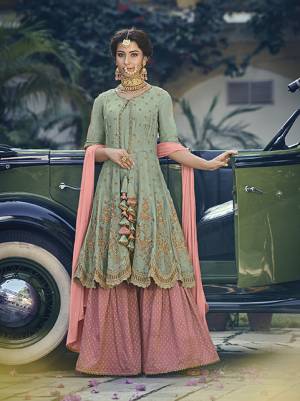 New And Unique Patterned Sharara Suit Is Here For You And Your Daighter In Light Green Colored Top Paired With Contrasting Pink Colored Bottom And Dupatta. Its Top Is Fabricated On Georgette Paired With Jacquard Silk Bottom And Chiffon Fabricated Dupatta. 