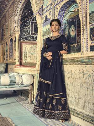 Enhance Your Personality In This Beautiful Designer Sharara Suit Availabe For You And Your Daughter In Navy Blue Color. Its Top Is Fabricated On Satin Georgette Paired With Net Fabricated Bottom And Dupatta. This Suit Also Ensures Superb Comfort And Easy To Carry Throughout The Gala.