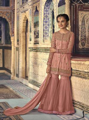 A Must Have Shade In Every Age Group Womens Wardrobe Is Here With This Peach Colored Designer Sharara Suit. This Pretty Suit Is Fabricated On Net Paired With Chiffon Fabricated Dupatta. Grab This Sharara Suit For You And Your Daughter Which Will Definitely Earn You Guys Lots Of Compliments From Onlookers. 