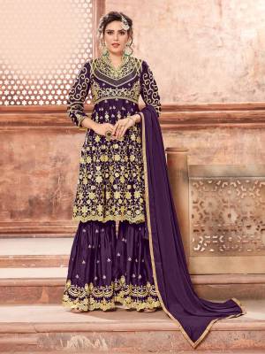 This Festive Season, Grab This Heavy Designer Sharara Suit In Purple Color Paired With Purple Colored Bottom And Dupatta. Its Heavy Embroidered Top And Bottom Are Fabricated On Satin Georgette Paired With Chinon Fabricated Dupatta. Buy This Semi-Stitched Suit Now.