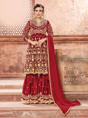 This Festive Season, Grab This Heavy Designer Sharara Suit In Red Color Paired With Red Colored Bottom And Dupatta. Its Heavy Embroidered Top And Bottom Are Fabricated On Satin Georgette Paired With Chinon Fabricated Dupatta. Buy This Semi-Stitched Suit Now.