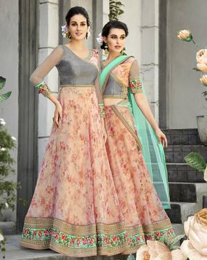 Here Is A Designer Lehenga Choli For The Upcoming Festive And Wedding Season. This Designer Lehenga Choli Can Be Stitched As A Floor Length Suit As Per Your Occasion. Its Blouse Is Fabricated On Art Silk And Net Paired With Oragenza Fabricated Floral Printed Lehenga And Net Fabricated Dupatta. Buy This Now.