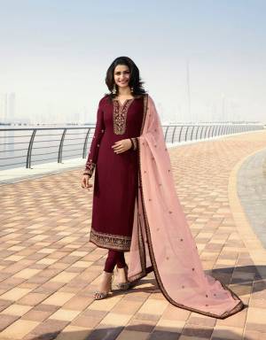 Here Is A Very Pretty Designer Straight Cut Suit In Maroon Color Paired With Contrasting Peach Colored Dupatta. Its Top Is Fabricated On Georgette Satin Paired With Santoon Bottom And Georgette Fabricated Dupatta. All Its Fabrics Are Light Weight And Easy To Carry All Day Long. 
