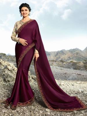 A Must Have Shade In Every Womens Wardrobe Is Here With This Designer Saree In Wine Color Paired With Cream Colored Blouse. This Saree And Blouse Are Silk Based Beautified With Prints And Embroidery Over The Blouse And Saree Lace Border.
