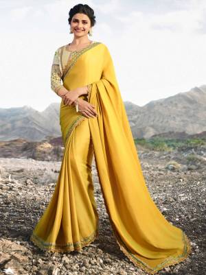 Celebrate This Festive Season With Ease And Comfort Wearing This Designer Saree In Yellow Color Paired With Cream Colored Blouse. This Saree Is Fabricated On Soft Silk Paired With Art Silk Fabricated Blouse. It Is Beautified With Prints And Embroidery Giving It An Attractive Look. 