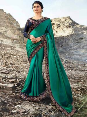 Grab This Pretty Designer Saree For The Upcoming Festive And Wedding Season With This Sea Green Colored Saree paired With Contrasting Navy Blue Colored Blouse. This Saree Is Fabricated On Soft Silk Paired With Art Silk Fabricated Blouse. It Is Beautified With Prints And Embroidery Over The Blouse are Lace Border.