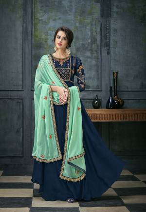 Bright And Visually Appealing Color Is Here With This Designer Floor Length Suit In Royal Blue Colored Top And Bottom Paired With Contrasting Sea Green Colored Dupatta. Its Top Is Fabricated On Satin Georgette Paired With Santoon Bottom And Chiffon Dupatta. 