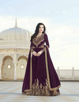 A Must Have Shade In Every Womens Wardrobe Is Here With This Designer Floor Length Suit In Wine Color Paired With Wine Colored Bottom And Dupatta. Its Embroidered Top And dupatta Are Fabricated On Georgette Paired With Santoon Fabricated Bottom. Buy Now.