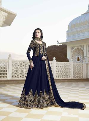 EnhanceYour Personality Wearing This Designer Floor Length Suit In Navy Blue Color Paired With Navy Blue Colored Bottom And Dupatta. Its Top And Dupatta Are Georgette Based Paired With Santoon Fabricated Bottom. 