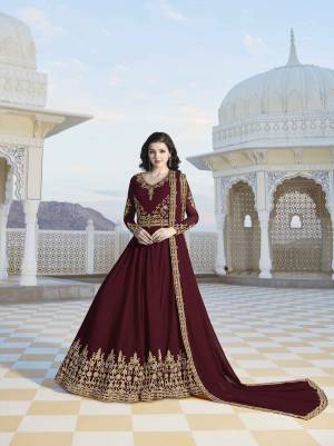 For A Royal Look, Grab This Designer Floor Length Suit In Maroon Color. Its Top And And Dupatta Are Georgette Fabricated Beautified With Heavy Jari Embroidery And Stone Work. You Can Wear This At The Wedding , Party Or As Any Festive Wear. 