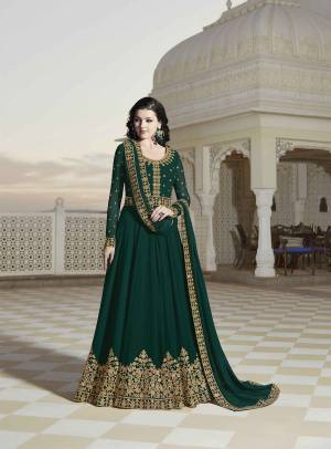 Celebrate This Festive And Wedding Season With Beauty And Comfort Wearing This Designer Floor Length Suit In Dark Green Color Paired With Dark Green Colored Bottom And Dupatta. Its Heavy Embroidered Top And Dupatta Are Georgette Based Paired With Santoon Fabricated Bottom. 