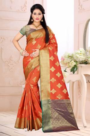 Celebrate This Festive Season Wearing This Saree In Orange Color Paired With Contrsating Purple Colored Blouse. This Saree Is Fabricated On Cotton Silk Paired With Jacquard Silk Fabricated Blouse. It Is Beautified With Weave All Over. 