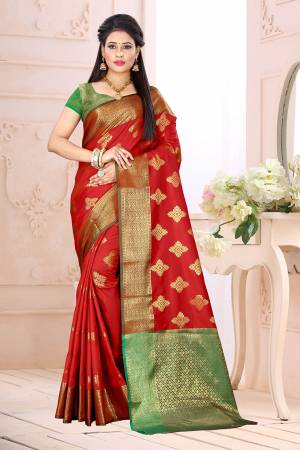 Celebrate This Festive Season Wearing This Saree In Red Color Paired With Contrsating Green Colored Blouse. This Saree Is Fabricated On Cotton Silk Paired With Jacquard Silk Fabricated Blouse. It Is Beautified With Weave All Over. 