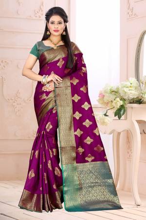 Celebrate This Festive Season Wearing This Saree In Magenta Pink Color Paired With Contrsating Blue Colored Blouse. This Saree Is Fabricated On Cotton Silk Paired With Jacquard Silk Fabricated Blouse. It Is Beautified With Weave All Over. 