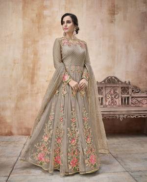 Flaunt Your Rich And Elegant Taste Wearing This Designer Floor Length Suit In Grey Color Paired With Grey Colored Bottom And Dupatta. Its Pretty Embroidered Floor Length Top IS Net Based Paired With Satin Silk Bottom And Net Dupatta.