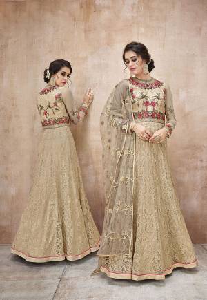 Simple and Elegant Looking Designer Floor length Suit IS Here In Beige Color Paired With Beige Colored Bottom And Dupatta. This Pretty Suit Is Net Based Paired With Satin Silk Fabricated Bottom. Buy This Now.