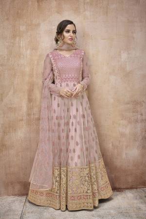 Look Pretty In This Pretty Designer Floor Length Suit In Baby Pink Color Paired With Baby Pink Colored Bottom And Dupatta. Its Top And Dupatta are Fabricated On Net Paired With Satin Silk Bottom. Its Fabrics Ensures Superb Comfort Throughout The Gala. 