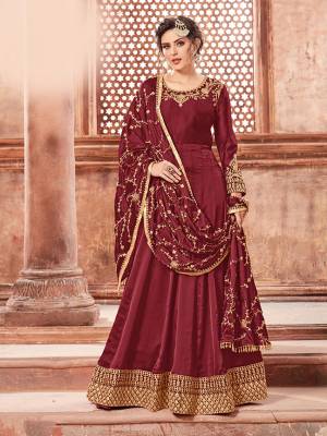 You Will Definitely Earn Lots Of Compliments Weairng This Designer Floor Length Suit In Maroon Color Paired With Maroon Colored Bottom And Dupatta. Its Top Is Fabricated On Satin Georgette Paired With Santoon Bottom And Heavy Embroidered Chinon Dupatta. The Main Highlight In This Designer Suit Is Its Embroidered Dupatta. Buy This Semi-Stitched Suit Now.