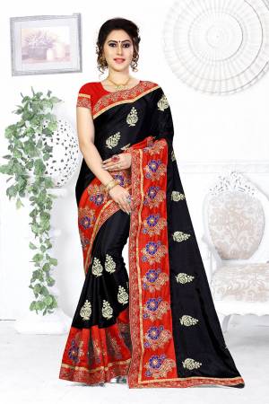 Here Is A Beautiful Designer Saree In Black Color Paired With Contrasting Red Colored Blouse. This Saree And Blouse are Silk Based Beautified With Contrasting Embroidery Making It More Attractive. Buy This Designer Saree Now.
