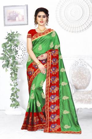 Here Is A Beautiful Designer Saree In Green Color Paired With Contrasting Red Colored Blouse. This Saree And Blouse are Silk Based Beautified With Contrasting Embroidery Making It More Attractive. Buy This Designer Saree Now.