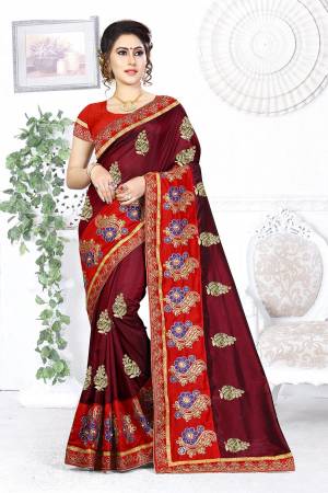 Here Is A Beautiful Designer Saree In Maroon Color Paired With Contrasting Red Colored Blouse. This Saree And Blouse are Silk Based Beautified With Contrasting Embroidery Making It More Attractive. Buy This Designer Saree Now.
