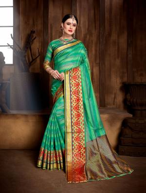 Celebrate This Festive Season With Ease And Comfort Wearing This Saree In Sea Green Color Paired With Sea Green Colored Blouse. This Saree And Blouse Are Fabricated On Banarasi Art Silk Beautified With Weave All Over. 