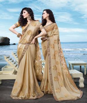 Flaunt Your Rich And Elegant Taste Wearing This Designer Saree In Beige Color Paired With Beige Colored Blouse. This Saree Is Fabricated On Georgette Satin Paired With Art Silk Fabricated Blouse. Its Rich Color And Embroidery Will Earn You Lots Of Compliments From Onlookers. 